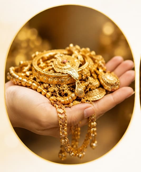 Gold jewellery held in a hand
